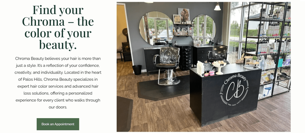 Interior view of Chroma Beauty salon featuring a stylish hair styling chair, a reception desk with the salon's logo, and a display of hair care products on shelves.